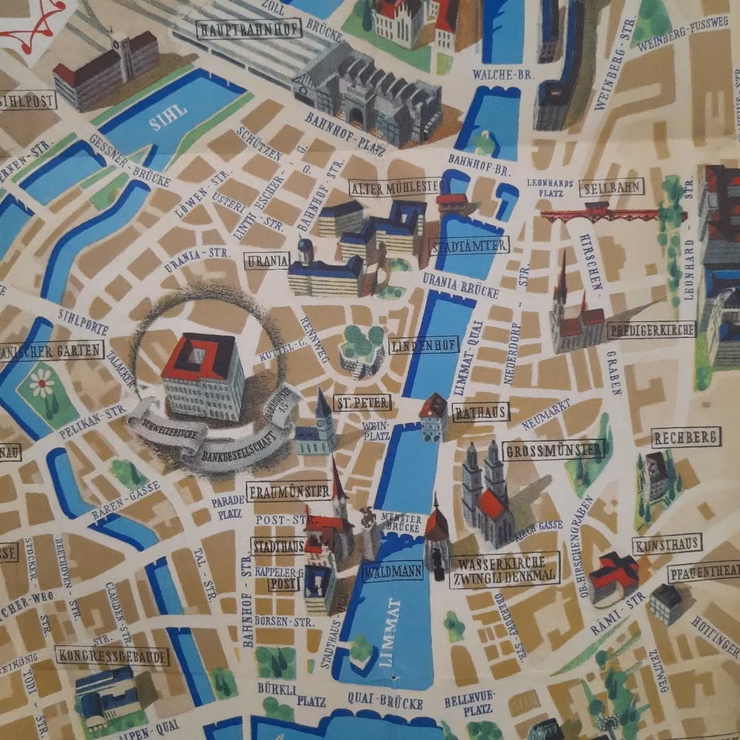 Gros plan sur la partie centrale de la carte picturale de Zurich, axé sur le centre-ville et la rivière Limmat, mettant en évidence des lieux comme le Rathaus, le Lindenhof, Fraumünster et le Grossmünster.