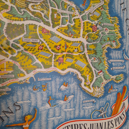 Vue générale de la carte touristique et picturale d'Antibes et Juan-les-Pins, une oeuvre colorée de 1949 par Vic Raymon montrant la ville et le Cap.